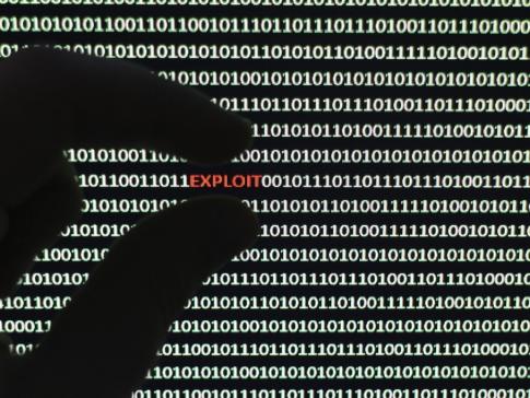 A photograph of a computer screen with the word exploit highlighted