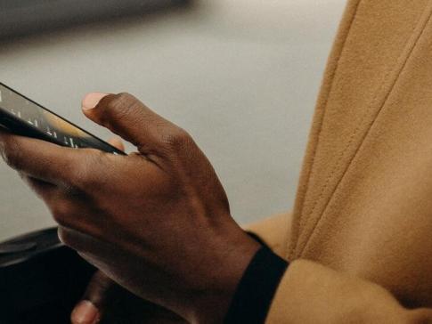 a photograph of a person holding an iphone