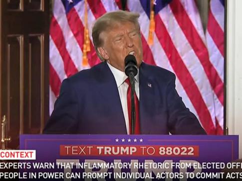 A screenshot of Former President Trump on PBS with added factual context captions