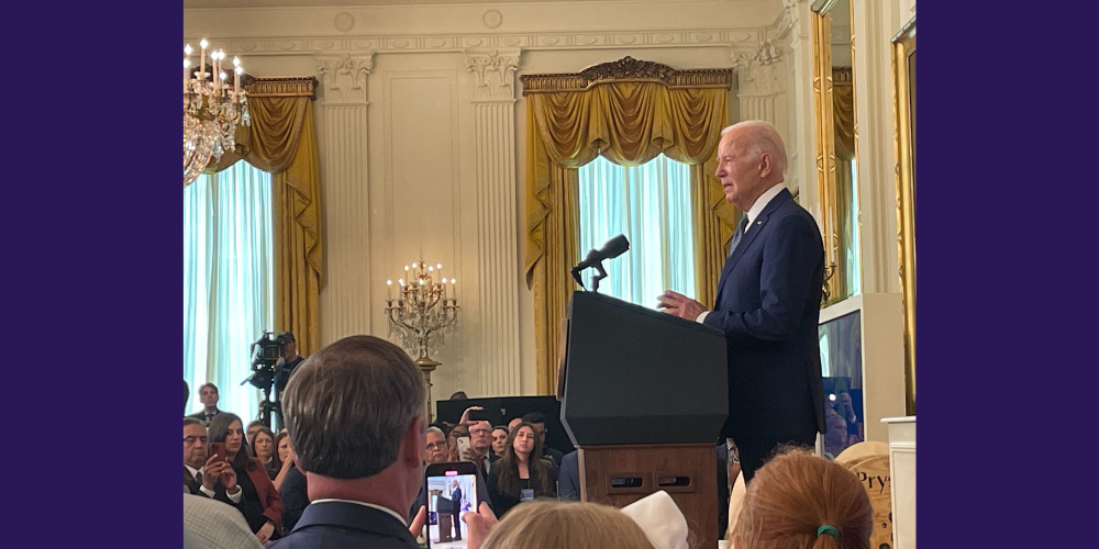 A photograph of President Biden delivering remarks at the White House