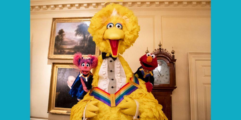 A photograph of Sesame Street characters Big Bird, Elmo and Abby at the White House