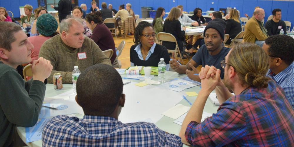 Community members in New Jersey sitting around a table discuss ways to strengthen local journalism.