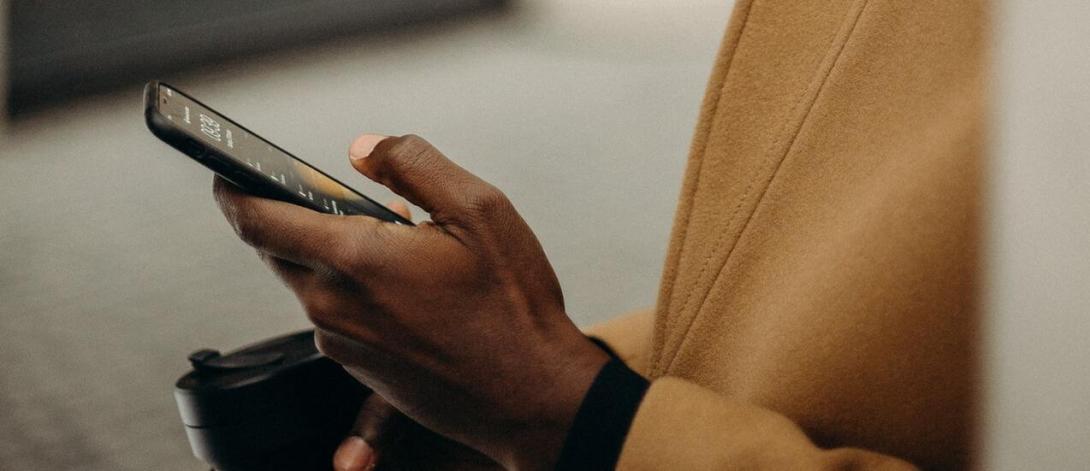 a photograph of a person holding an iphone